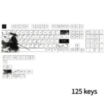 A vibrant Qi original character keycap set showcasing various unique designs from different angles, enhancing the artistic aesthetic of a custom mechanical keyboard.