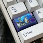 Iconic Rei Ayanami titanium artisan keycap, 1.75U Shift, shown from various angles. Highlights premium craftsmanship and sleek metallic finish.