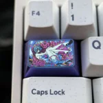 Close-up of the iconic Rei Ayanami Titanium Artisan Keycap (1.5U Tab) showcasing its vibrant colors and lustrous finish from a unique angle.
