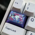 Detailed view of the iconic Rei Ayanami titanium artisan keycap, showcasing its vibrant colors and lustrous finish from a dynamic angle.
