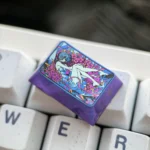 Close-up of the iconic Rei Ayanami Titanium Artisan Keycap (1.5U Tab) from a different angle, showcasing its vibrant colors and lustrous finish.