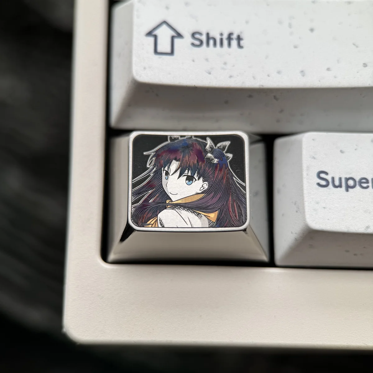 Exclusive Rin Tohsaka Titanium Keycap for gaming, showcasing sleek anodized titanium with intricate Fate/Stay Night character art. Premium quality.