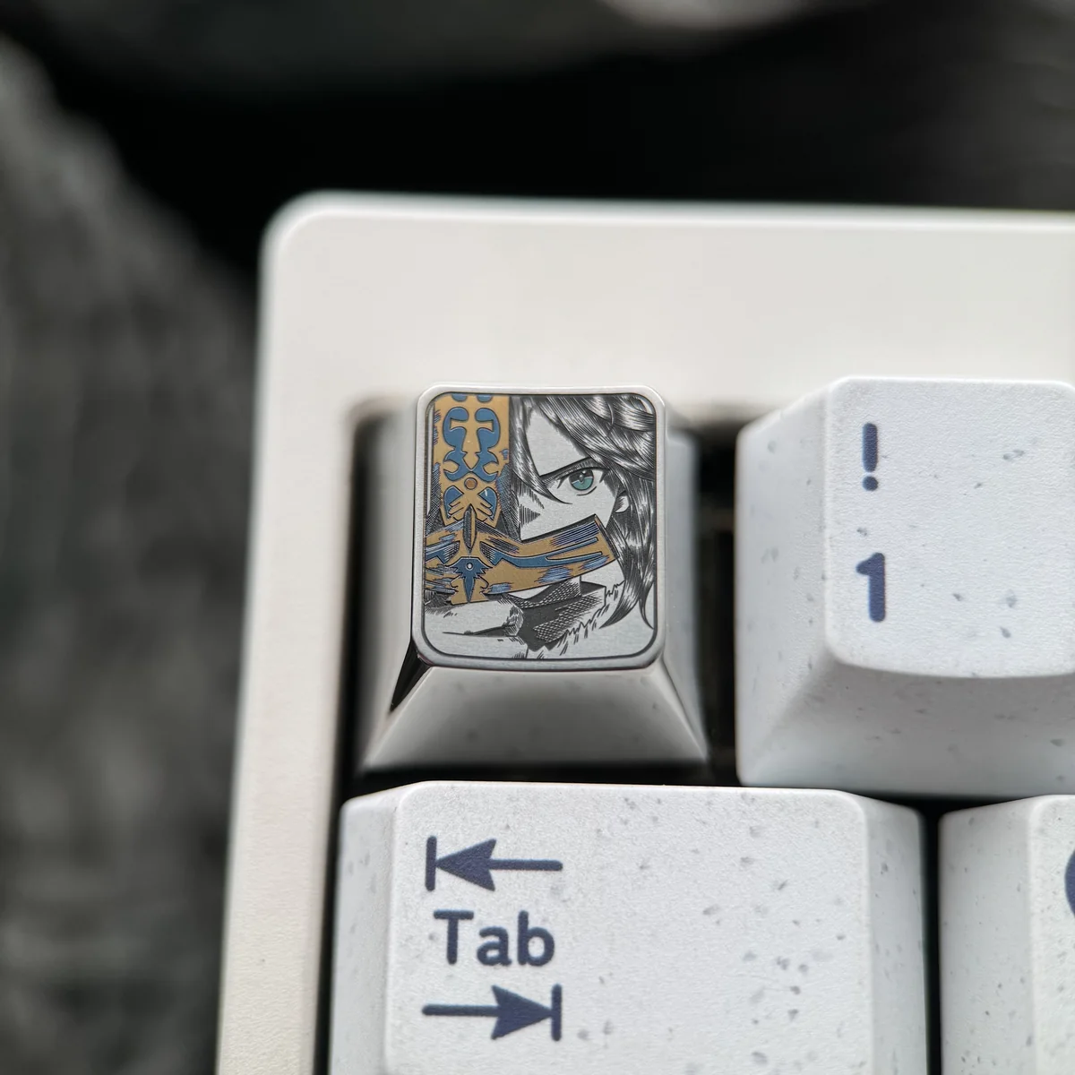 Close-up of the premium Saber Titanium Keycap, showcasing its iconic anime art design and dazzling iridescent ice crystal finish with precise detail.