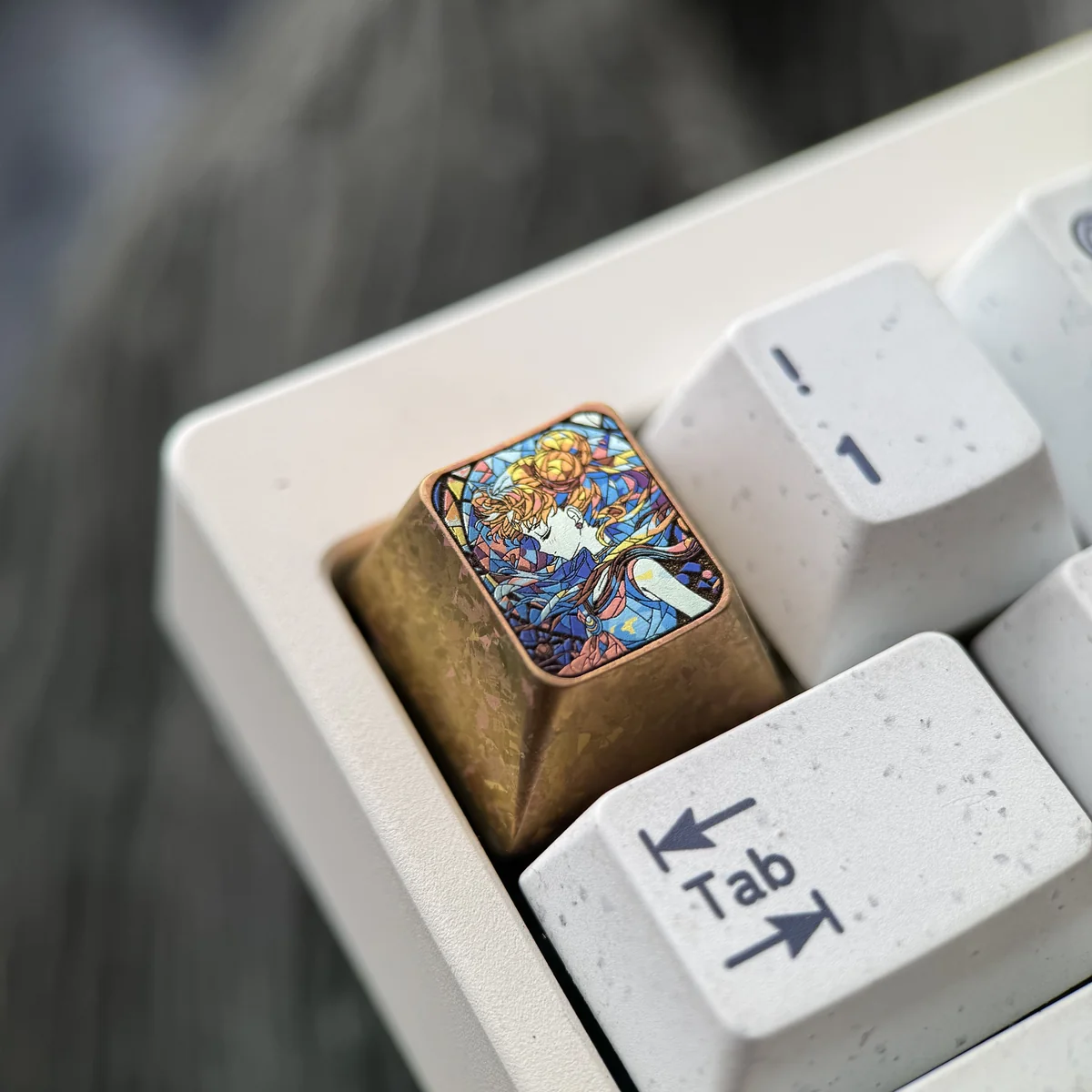 A detailed view of the iconic Sailor Moon Titanium Shattered Glass Keycap, showcasing its vibrant anime artistry and unique shattered glass titanium.