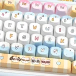 Artistic gallery of Seaside PBT Keycaps set, revealing intricate dye-sub designs in serene ocean blues and warm sandy tones, capturing tranquil beach.