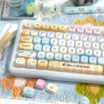 Seaside PBT Keycaps set from various angles, showcasing immersive ocean blues, warm sandy dye-sub tones, and artistic tranquil beach landscapes for your keyboard.