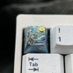 Close-up of the premium titanium ESC keycap, showcasing the vibrant Van Gogh Starry Night design with swirling cosmic blues and yellows.