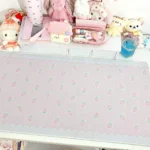 An overhead view of the cheerful strawberry desk mat, displaying its full charming design and the choice between two unique materials.