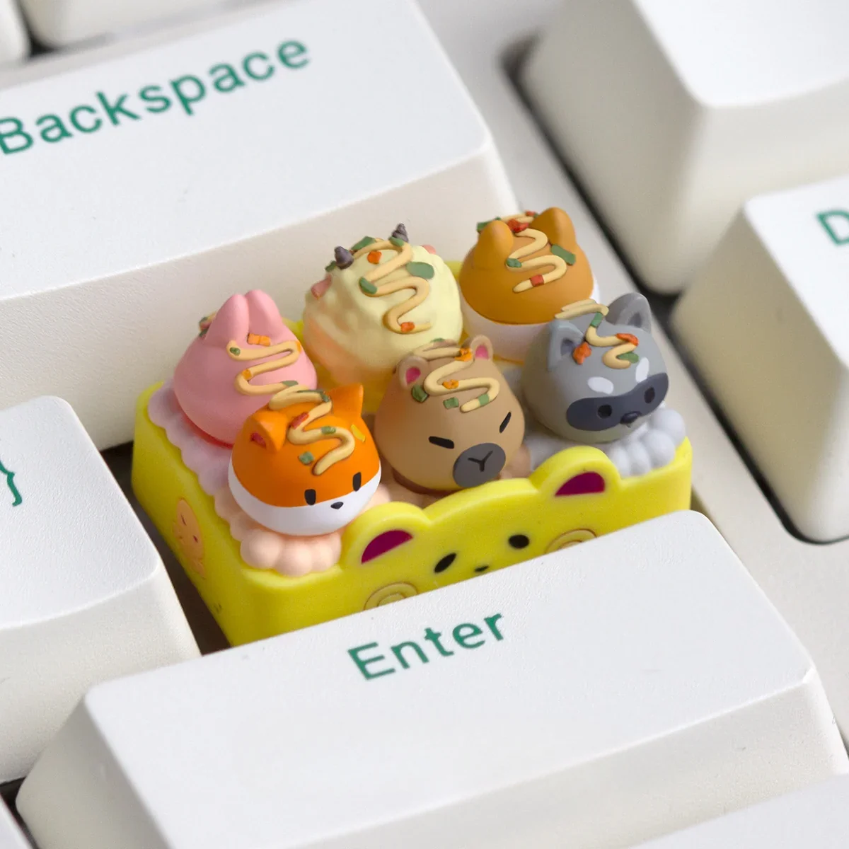 Close-up of a whimsical handcrafted resin Takoyaki artisan keycap, showcasing its vibrant miniature Japanese street food details for mechanical keyboard.