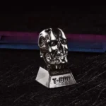 Iconic Terminator T800 artisan resin keycap, showcasing its gritty cybernetic skull design and metallic finishes from a powerful, detailed angle.
