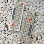 Elegant CNC Aluminum 67-key V65 mechanical keyboard, presented from a slight angle, emphasizing its sleek minimalist design and premium dual-mode connection.