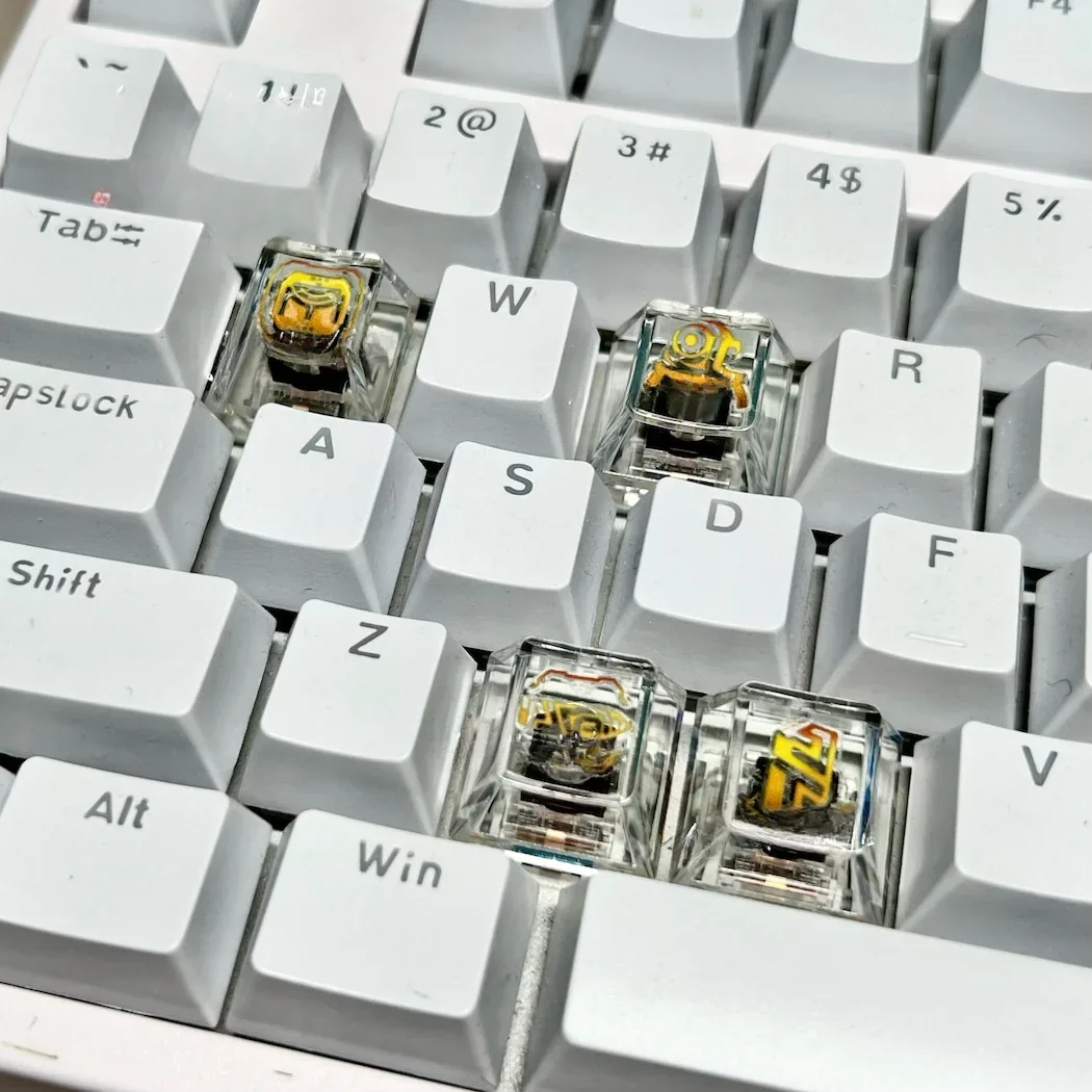 Close-up of the sleek, transparent Valorant Chamber ability keycaps, showcasing their premium white design and tactical elegance from a unique angles.
