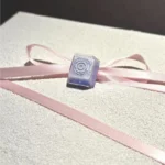Handcrafted Valorant Iso skill artisan keycap, dynamically sculpted to capture Iso's energy, shown in a detailed close-up view.