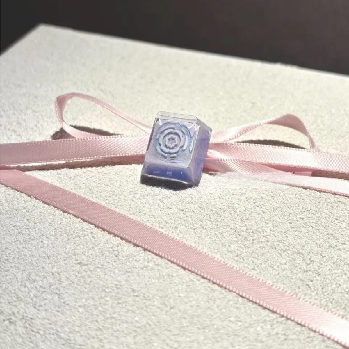 Handcrafted Valorant Iso skill artisan keycap, dynamically sculpted to capture Iso's energy, shown in a detailed close-up view.