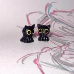 Close-up of a handcrafted Valorant Troublemaker Capsule artisan keycap, showcasing its mischievous dark grey design and intricate hand-sculpted details.