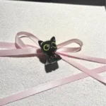 Close-up of a handcrafted Valorant Troublemaker Capsule artisan keycap, showcasing its mischievous dark grey design. This unique Valorant keycap.