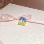 A close-up view of the handcrafted Valorant Neon Q Skill artisan keycap, showcasing its vibrant, electrifying design from a unique angle.