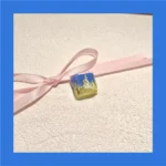 A close-up view of the handcrafted Valorant Neon Q Skill artisan keycap, showcasing its vibrant, electrifying design from multiple dynamic angles.