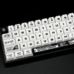 A collection of Warframe PBT keycaps set shown from various angles, highlighting the exclusive dark sci-fi art and intricate character designs.