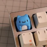 Whimsical Bugcat Capoo artisan keycap crafted from vibrant resin, featuring the chubby character's adorable details from various angles in SA profile.