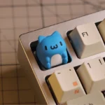 Whimsical Bugcat Capoo artisan resin keycap, captured from a unique angle, highlighting its adorable chubby character and vibrant SA profile.