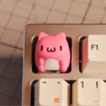 Adorable Bugcat Capoo artisan resin keycap, showcasing its cute, chubby character and vibrant SA profile from a dynamic side angle.