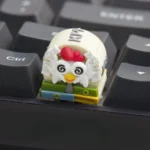 Close-up views of the whimsical handcrafted resin Working Chicken Keycap, showcasing its vibrant colors and intricate details from various angles.