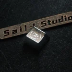 Close-up view of a premium metal World of Warcraft Alliance faction keycap, highlighting its iconic symbol's intricate details and stunning metallic design.