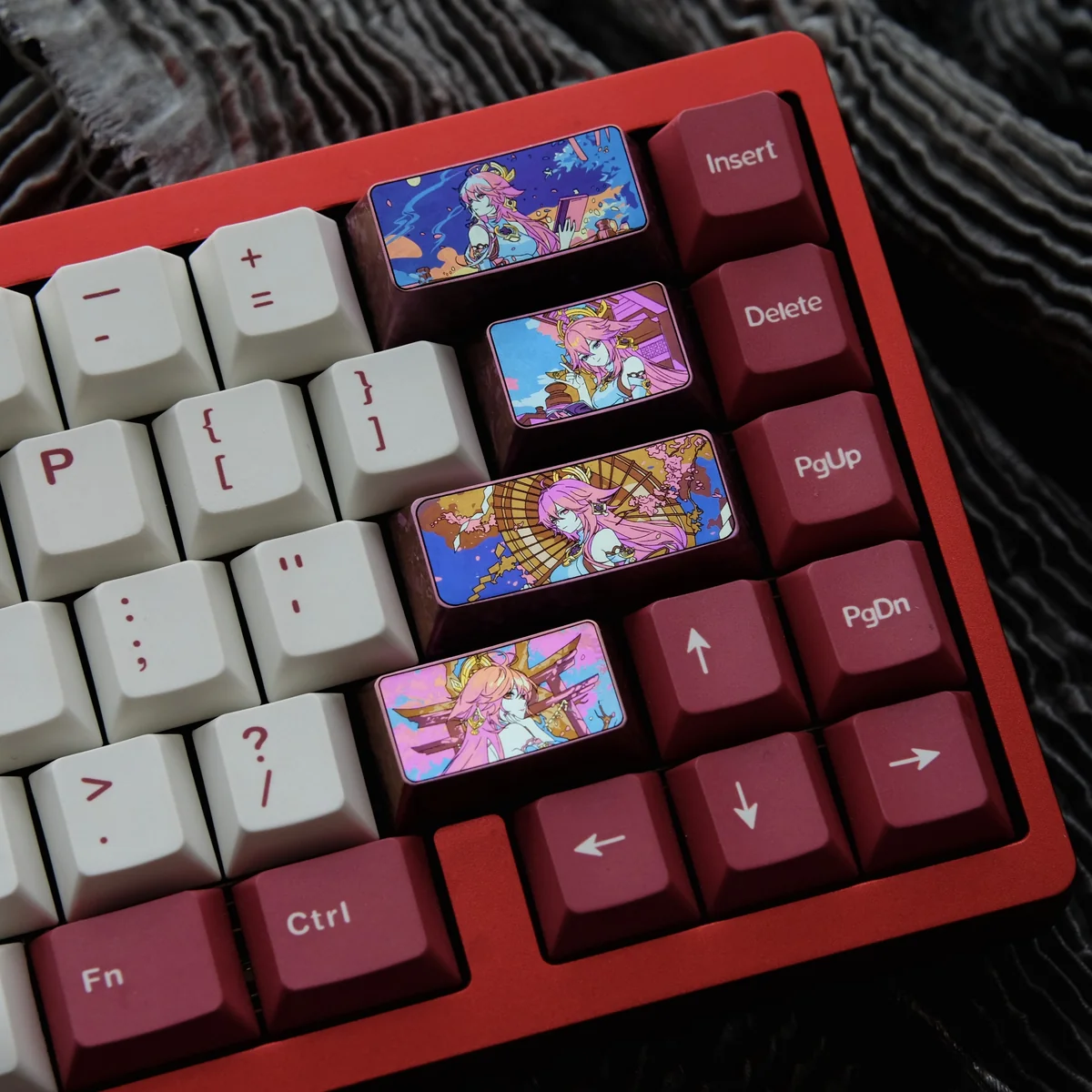 Close-up of a premium Yae Miko titanium ice-crystal keycap for Genshin Impact, showcasing vibrant character motifs and iridescent effects on anodized.
