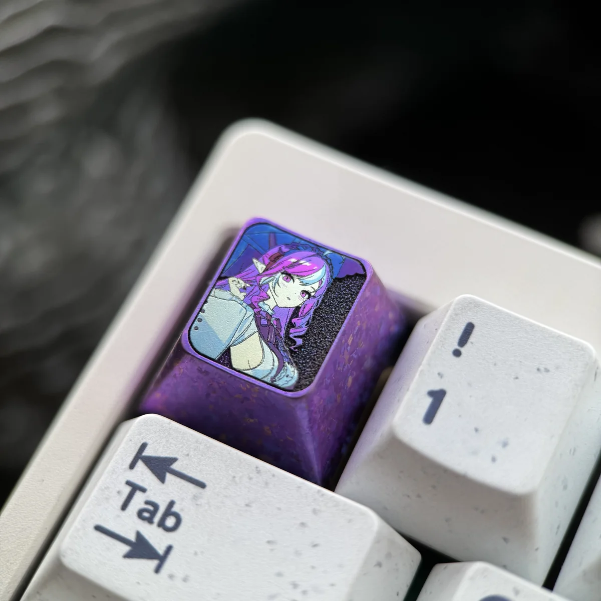 Vivian Banshee Titanium Zenless Zone Zero Keycap, showcasing its sleek metallic finish and intricate sci-fi detailing from a unique angle.