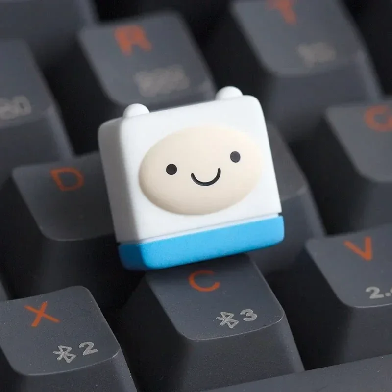 Adventure Time: Whimsical Finn Keycap, a vibrant handcrafted piece, brings animated joy and custom style to your keyboard setup.