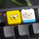 "Detailed view of the playful handcrafted translucent Adventure Time Jake ESC keycap, showcasing its vibrant, glowing resin and cartoon-inspired design."
