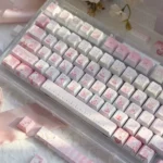 Vibrant Aikatsu! PBT keycaps set from a playful angle, displaying cheerful anime characters, musical notes, and the full 130-key layout for fans.