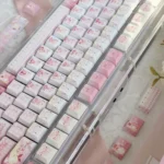 Vibrant Aikatsu! PBT keycaps set, showcasing cheerful anime characters and musical motifs from multiple angles. This durable 130-key set brings idol activities.