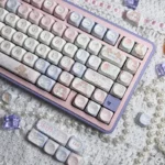 Cute Angel Bear PBT MOA Keycaps set in soft pink, displaying adorable angel bear designs from multiple angles, perfect for a charming, playful keyboard.