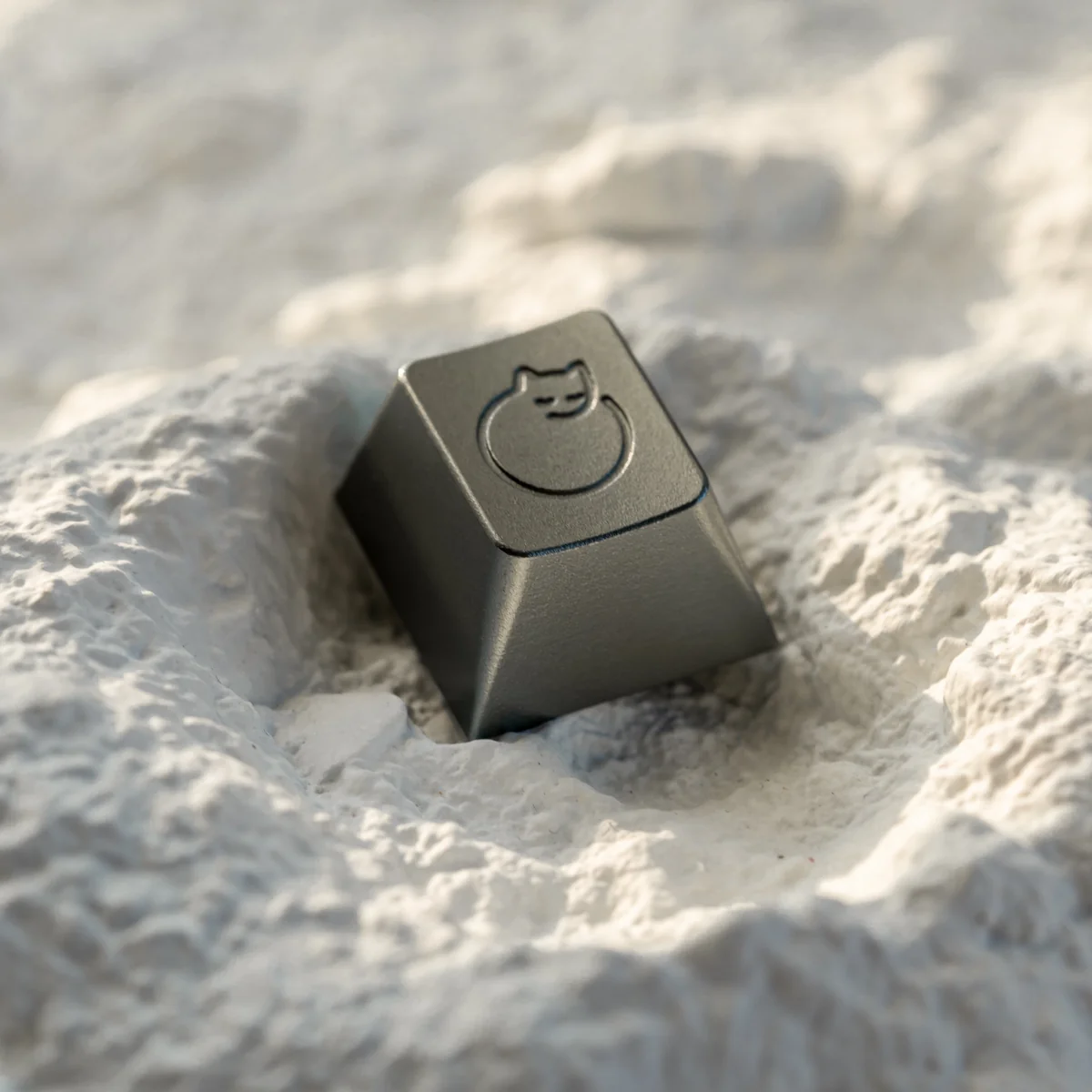 A serene, handcrafted aluminum sleeping cat artisan ESC keycap, meticulously detailed and whimsically designed for mechanical keyboards.