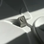 Premium CNC aluminum artisan keycap, showcasing its pyramid and alien designs from a distinct angle. Highlights durable metallic craftsmanship.