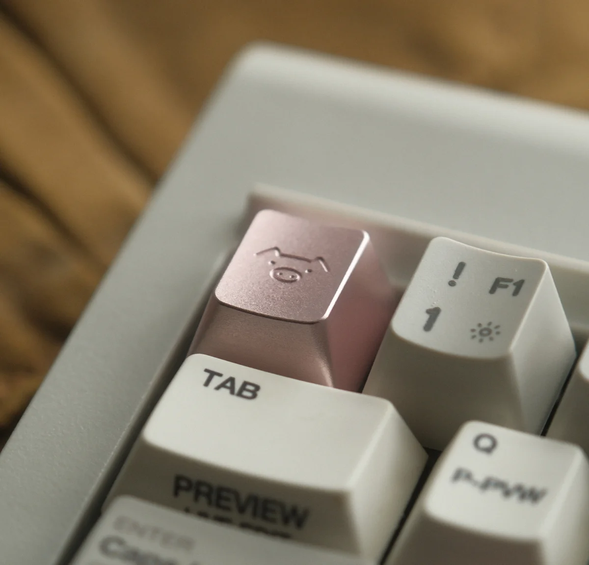 A collection of handcrafted aluminum alloy artisan pig keycaps from various angles, showcasing their whimsical design and lustrous metallic finish.