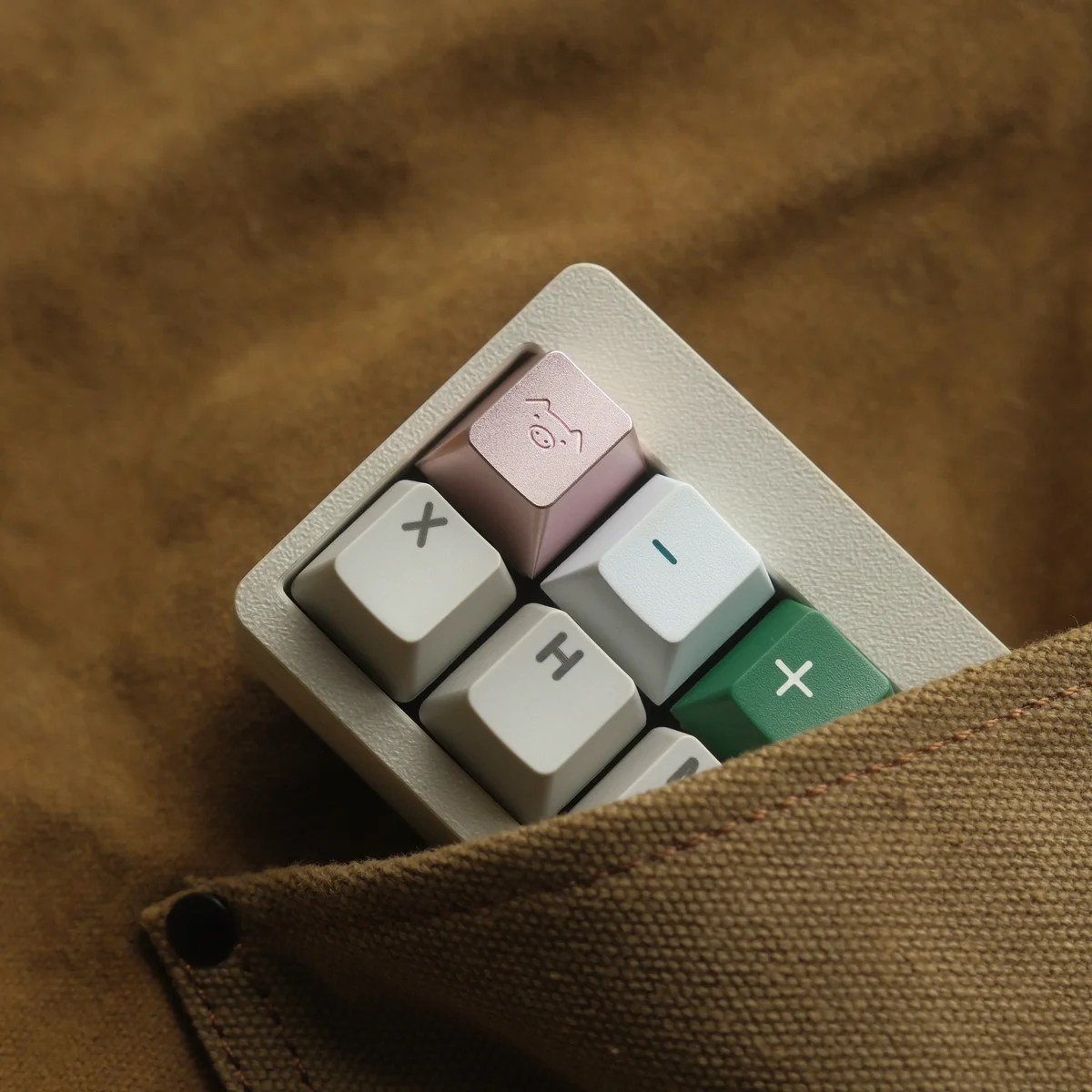 Detailed views of the handcrafted aluminum alloy Artisan Pig Keycap, showing its whimsical design and lustrous metallic finish from various angles.