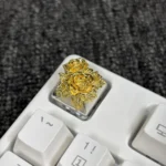 Close-up of an opulent gold-plated pure copper artisan rose keycap, showcasing its intricate metallic details and artistic craftsmanship.