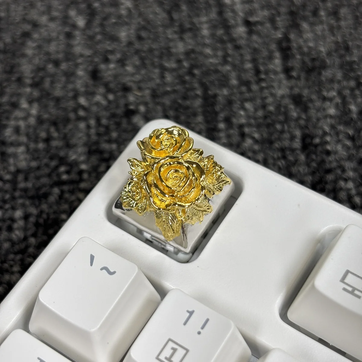 Close-up of an opulent gold-plated pure copper artisan rose keycap, showcasing its intricate metallic details and artistic craftsmanship.