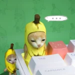 Gallery views of the adorable handcrafted Banana Cat Keycap, a playful artisan ESC key, showcasing its meticulously sculpted feline and whimsical keycap.