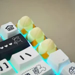 Multiple views of a whimsical handcrafted banana resin keycap (1U), highlighting its vibrant yellow, playful miniature fruit design and intricate detailed.