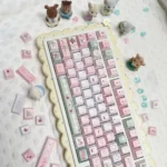Whimsical picnic bear PBT dye-sub cute bear keycaps set, showcasing multiple adorable keycap designs from various angles with pastel hues and charming setup.