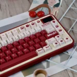 Discover the charming Berry Box PBT Dye-Sub Keycap Set through multiple vibrant angles, highlighting its playful red strawberry and box motifs.