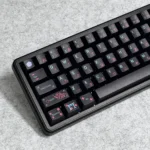 Angled view of Serene Black Japanese PBT Keycaps Set, highlighting the durable dye-sublimated design with elegant dark tones, natural motifs.