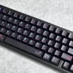 Serene Black Japanese PBT Dye-Sublimated Keycaps Set. Durable PBT set, elegant dark tones, natural motifs, and Kanji legends, shown from a unique angle.