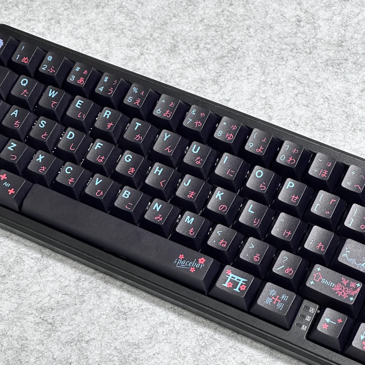 Serene Black Japanese PBT Dye-Sublimated Keycaps Set. Durable PBT set, elegant dark tones, natural motifs, and Kanji legends, shown from a unique angle.