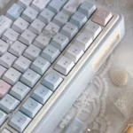 The Blue Rain PBT keycap set is artfully displayed from a new angle, revealing its immersive deep blues and delicate rain motifs for a serene design.