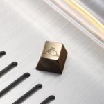 Gallery of the Handcrafted Brass Whale ESC Keycap, showcasing its mirror-polished luxury and intricate design from various angles, reflecting deep ocean.